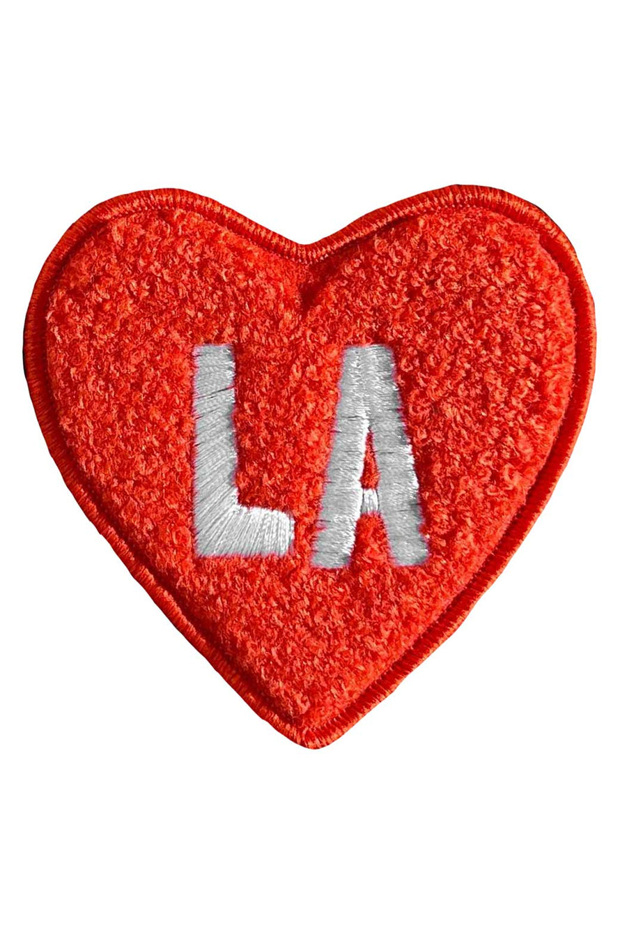 Red heart-shaped patch with 'LA' embroidered on a white background